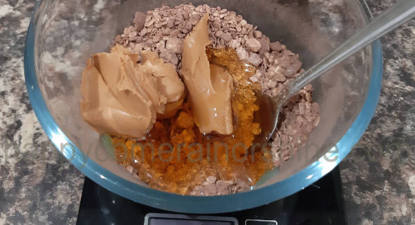 Mixture in the bowl with the peanut butter and honey added