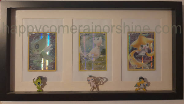 Pokemon card display in a frame with pins