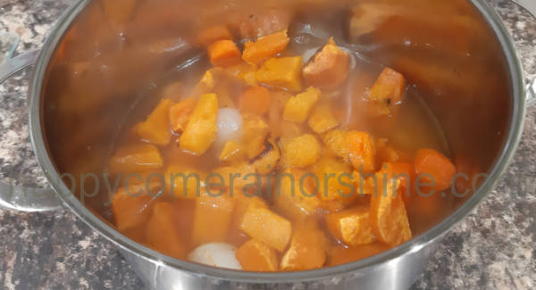 Roasted ingredients added into a large saucepan.